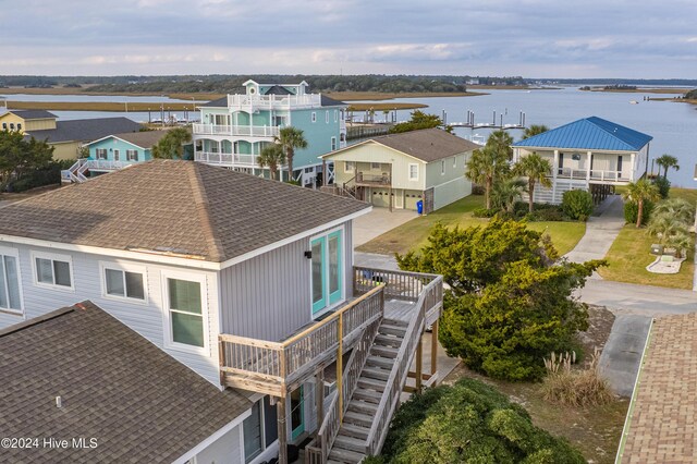 rear view of house featuring a patio area, a sunroom, and a balcony