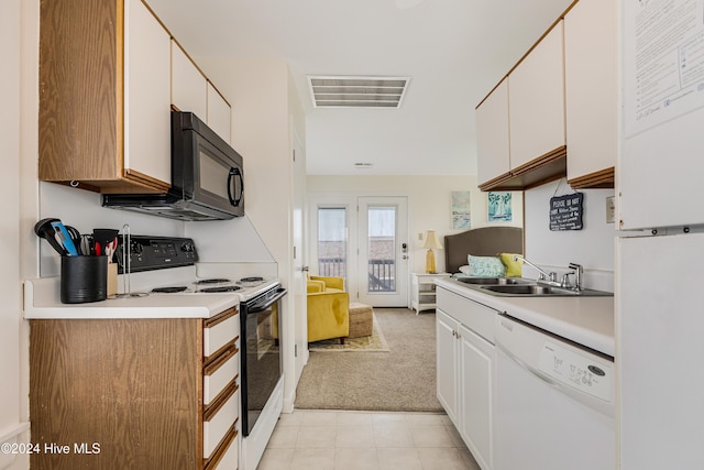 kitchen with white cabinets, light colored carpet, white appliances, and sink