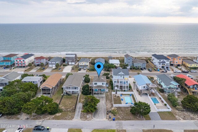 drone / aerial view with a water view and a view of the beach