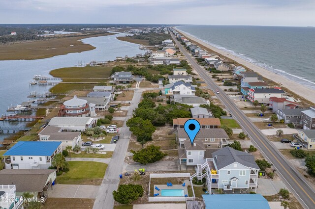 birds eye view of property with a beach view and a water view