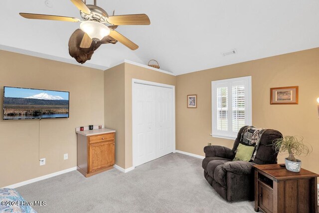 sitting room featuring ceiling fan, lofted ceiling, and light carpet