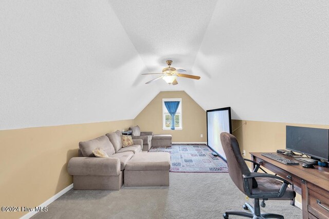 home office featuring a textured ceiling, vaulted ceiling, and carpet