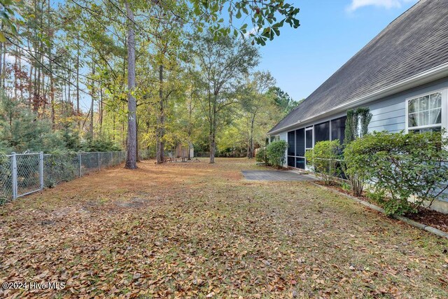 view of yard featuring a sunroom