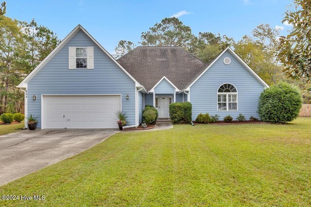 view of front of property with a garage and a front lawn