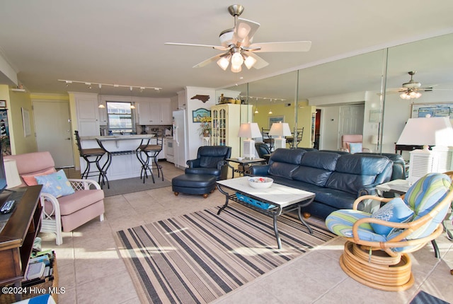 living room with ceiling fan, light tile patterned floors, crown molding, and track lighting