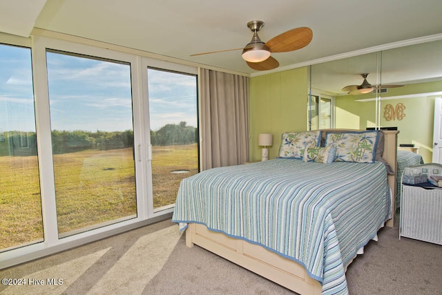 bedroom with carpet flooring, access to outside, and ceiling fan