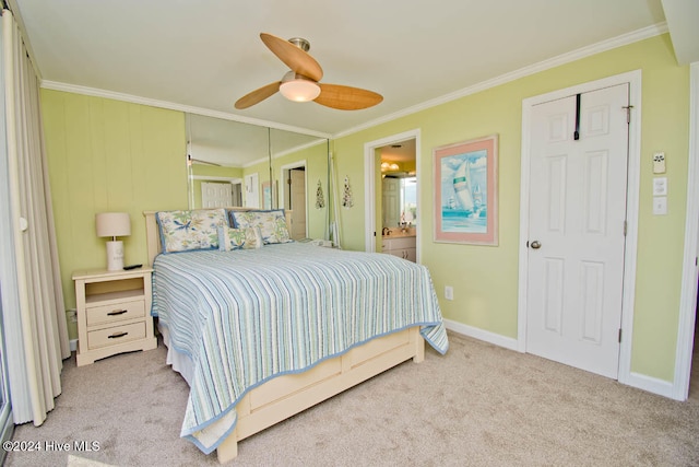 carpeted bedroom with ensuite bathroom, crown molding, and ceiling fan