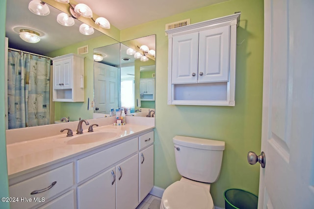 bathroom featuring vanity, a shower with shower curtain, and toilet