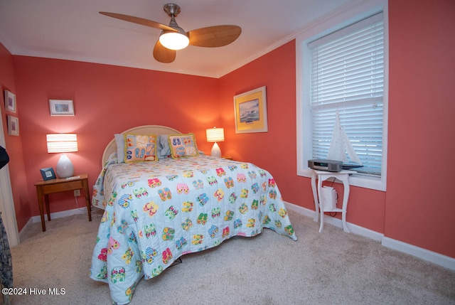 carpeted bedroom featuring ceiling fan and ornamental molding