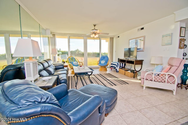 living room featuring light tile patterned floors, ceiling fan, and crown molding