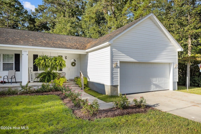 ranch-style house with a front yard, a porch, and a garage