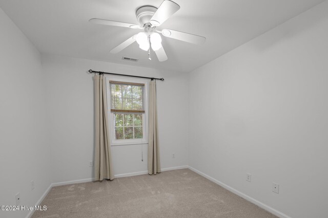 unfurnished bedroom featuring ceiling fan and light carpet