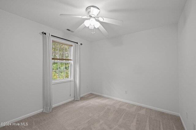 unfurnished bedroom featuring ceiling fan, baseboards, a closet, and light colored carpet