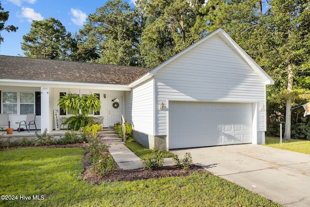 ranch-style home featuring a porch, a garage, and a front yard