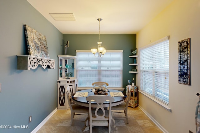 dining area with plenty of natural light and an inviting chandelier