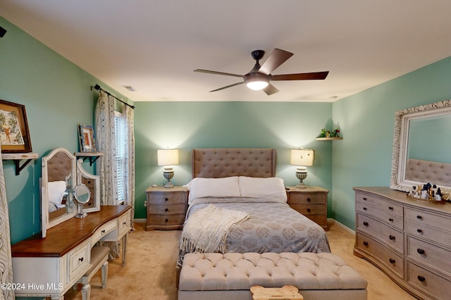 bedroom with ceiling fan and light carpet