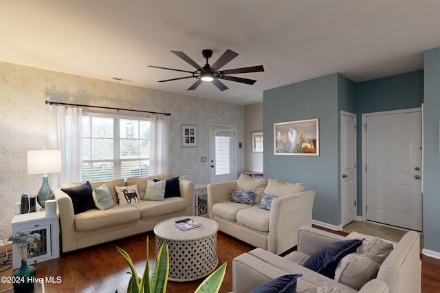 living room with wood-type flooring and ceiling fan