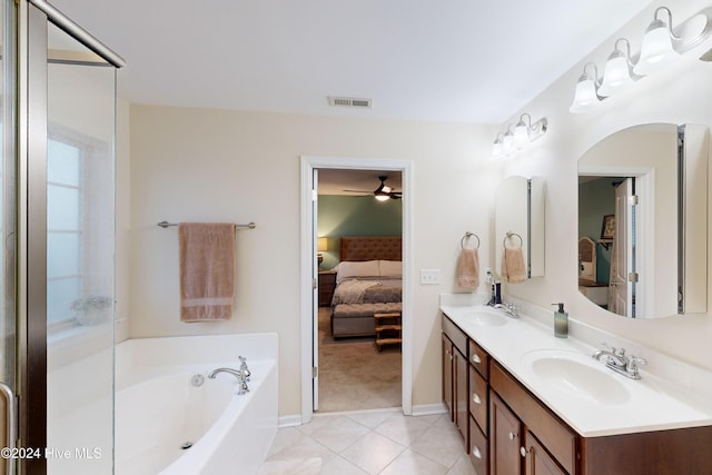 bathroom with tile patterned floors, vanity, and a tub