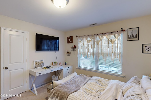 carpeted bedroom featuring multiple windows