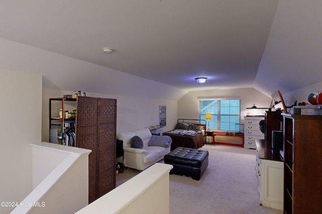 bedroom with light carpet and vaulted ceiling