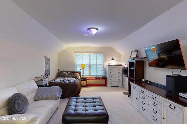 carpeted bedroom with lofted ceiling