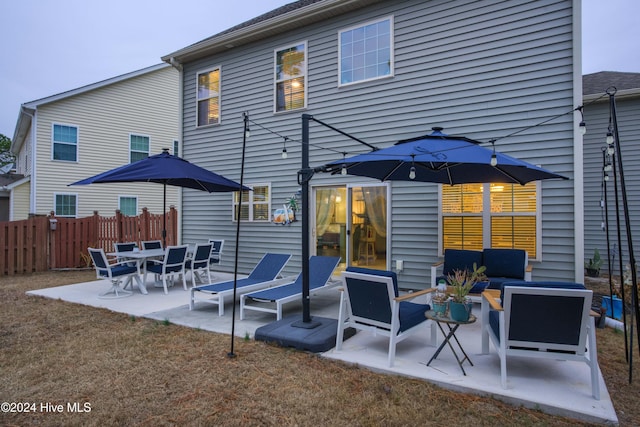 back of property featuring a patio and an outdoor hangout area