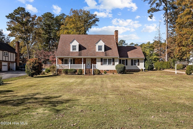 cape cod home with covered porch and a front lawn