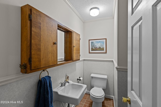 bathroom with crown molding, sink, a textured ceiling, and toilet