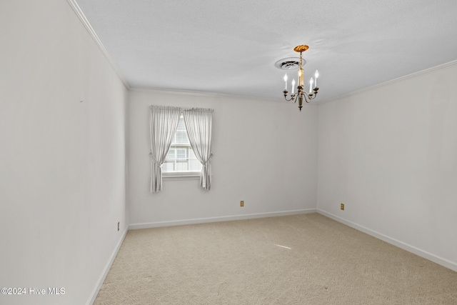 spare room featuring a notable chandelier, light colored carpet, ornamental molding, and a textured ceiling