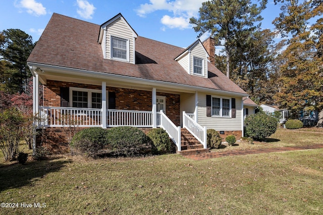 cape cod house featuring a porch and a front lawn