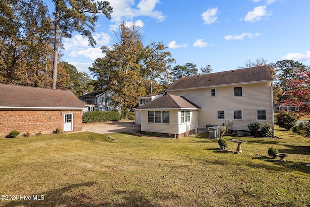 back of house with a yard