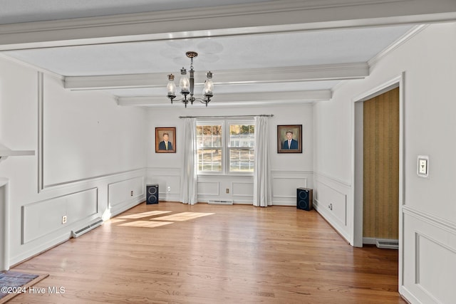 unfurnished dining area with beam ceiling, light wood-type flooring, ornamental molding, and a notable chandelier