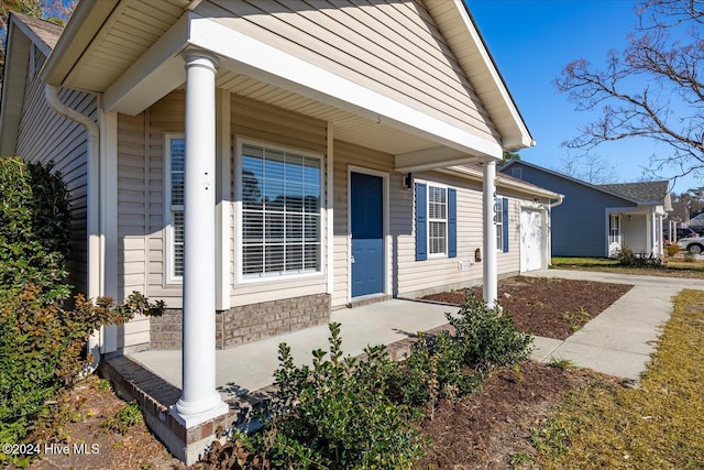 view of exterior entry featuring a porch