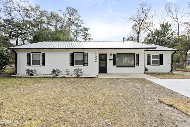 ranch-style house featuring covered porch and a front lawn