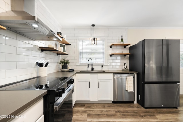 kitchen with pendant lighting, sink, stainless steel appliances, white cabinets, and exhaust hood