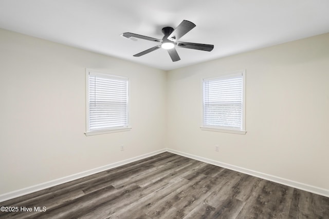 spare room featuring dark wood-type flooring and ceiling fan