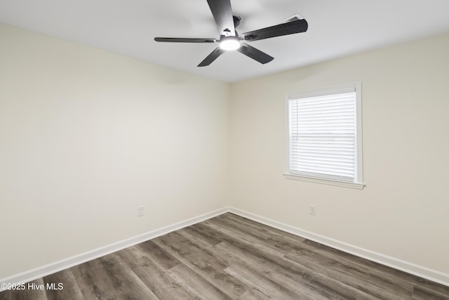 empty room featuring ceiling fan and dark hardwood / wood-style flooring