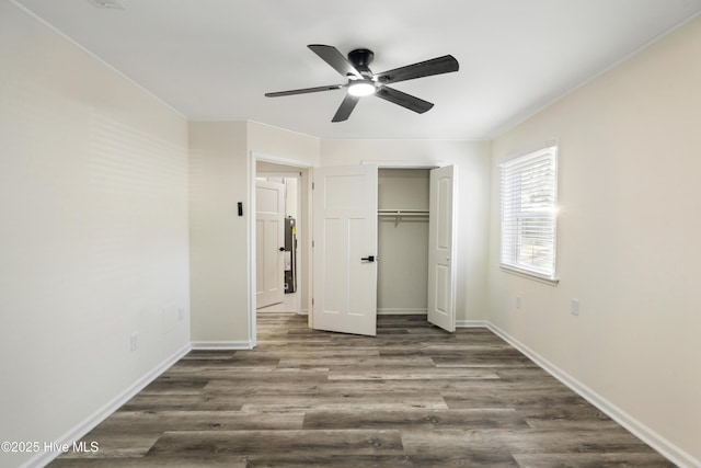 unfurnished bedroom featuring ceiling fan, dark hardwood / wood-style flooring, and a closet