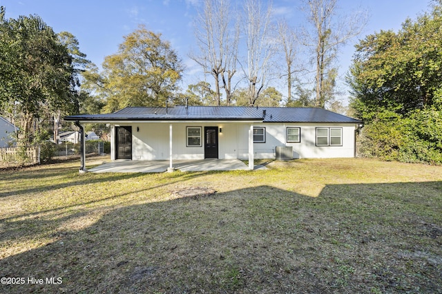 back of property featuring a lawn, cooling unit, and a patio area