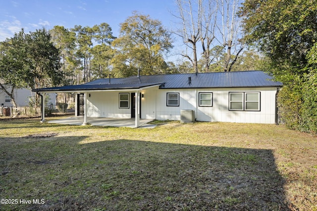 rear view of house featuring central AC, a patio, and a lawn