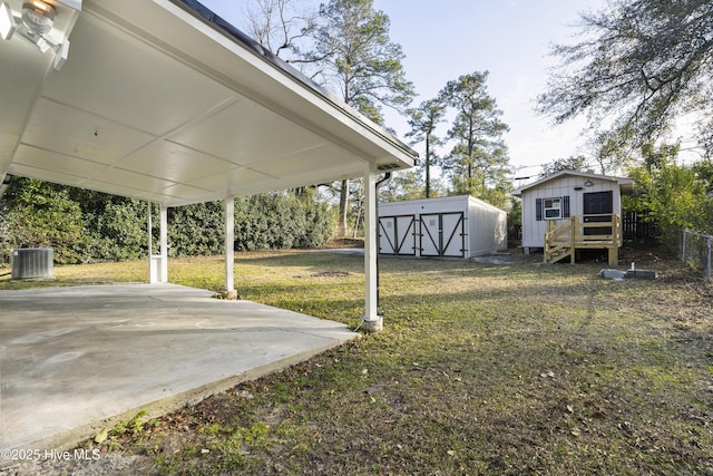 view of yard with cooling unit, a storage shed, and a patio