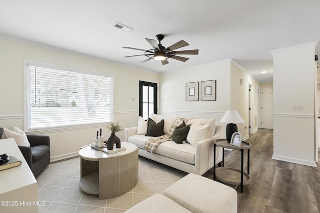 living room featuring ornamental molding, ceiling fan, and light hardwood / wood-style flooring