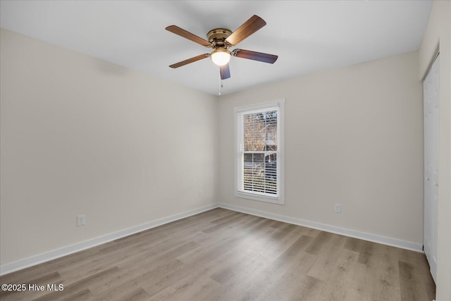 unfurnished room with ceiling fan and light wood-type flooring