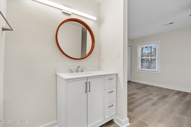 bathroom with vanity and hardwood / wood-style floors