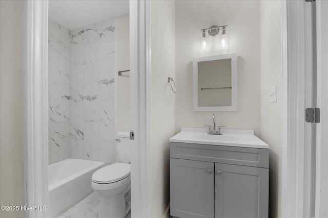 full bathroom featuring vanity, tiled shower / bath, and toilet