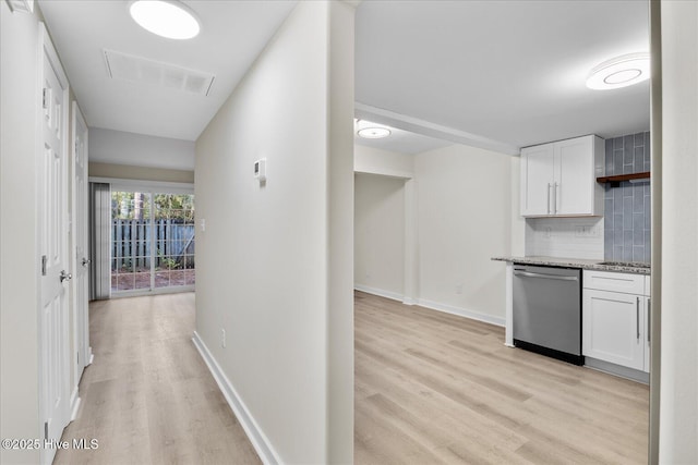 hallway with light hardwood / wood-style floors