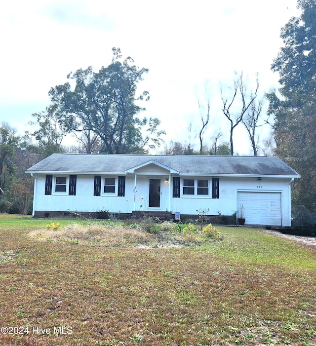 ranch-style house with a garage and a front lawn