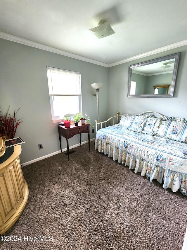 bedroom with baseboards, dark carpet, and ornamental molding