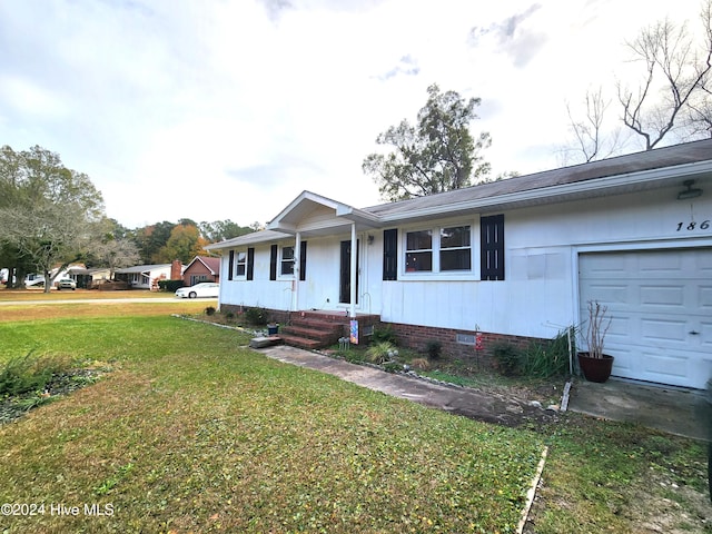 ranch-style home with a front lawn and a garage