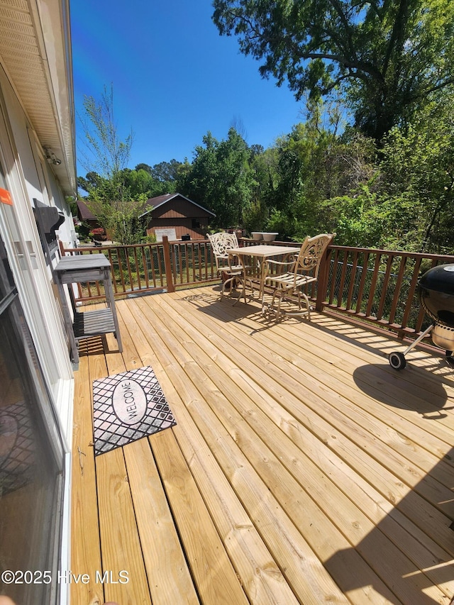 wooden deck with outdoor dining area